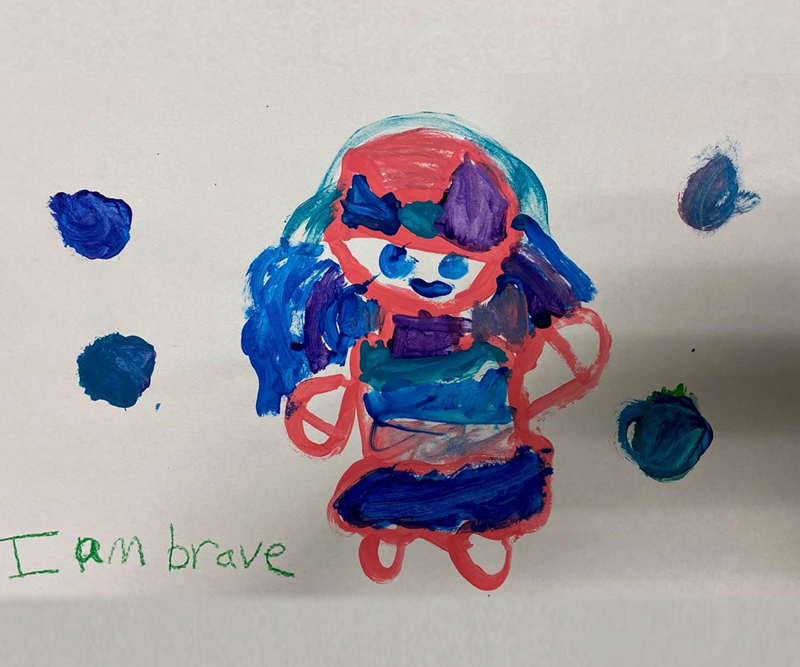 Drawing of a little girl that says "I am brave" at the bottom, which was created by B.