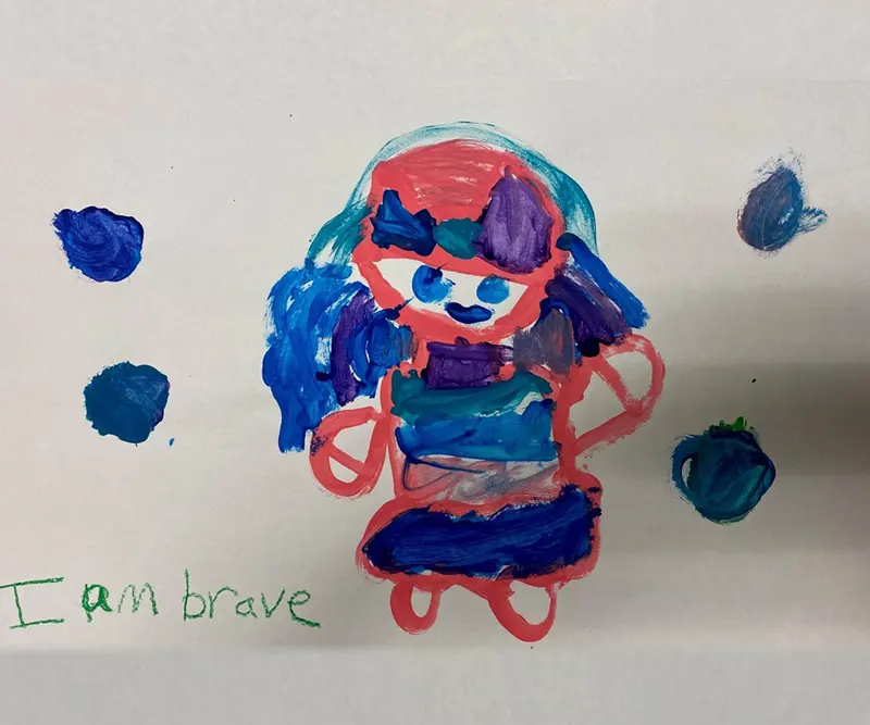 Drawing of a little girl that says "I am brave" at the bottom, which was created by B.