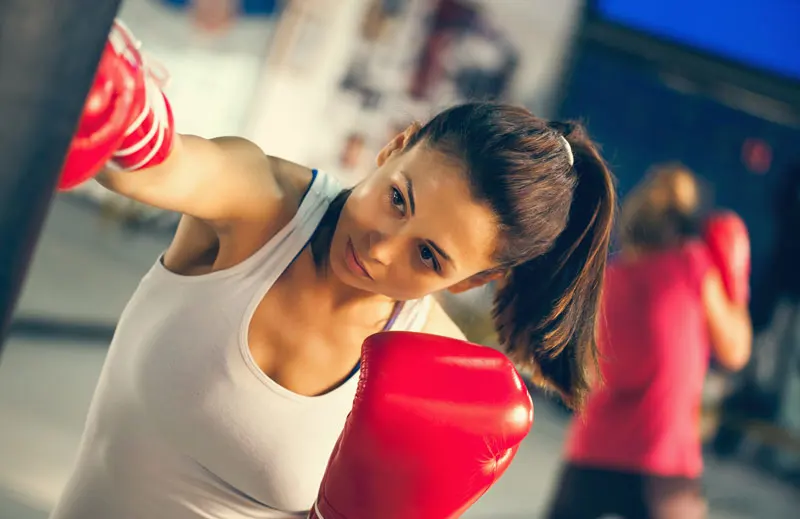 A female boxer punching a bag.