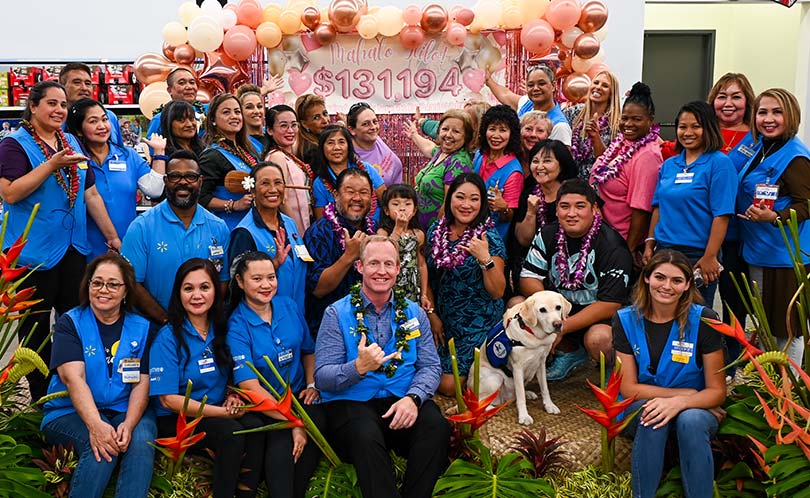 Group of walmart employees celebrating their fundraising efforts with Kapiolani's CMN Champion Kalley-mae and her family.